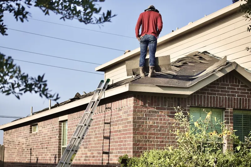 Professional roofer working on a residential roof in Joint Forces Training Base